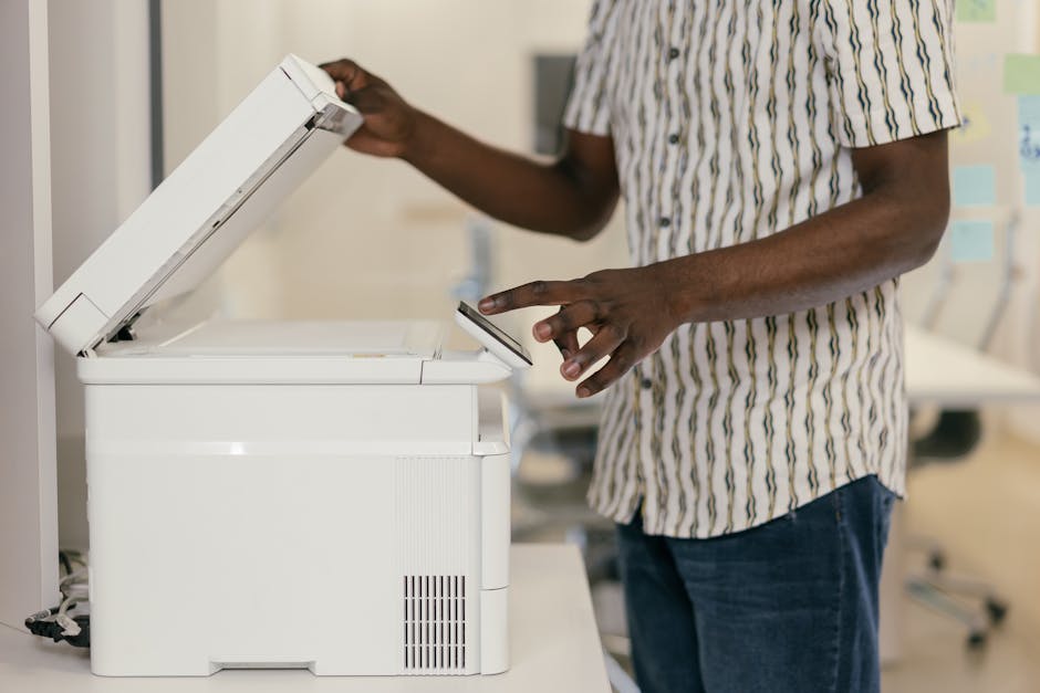 Commercial printing professional working with modern equipment by Mikhail Nilov